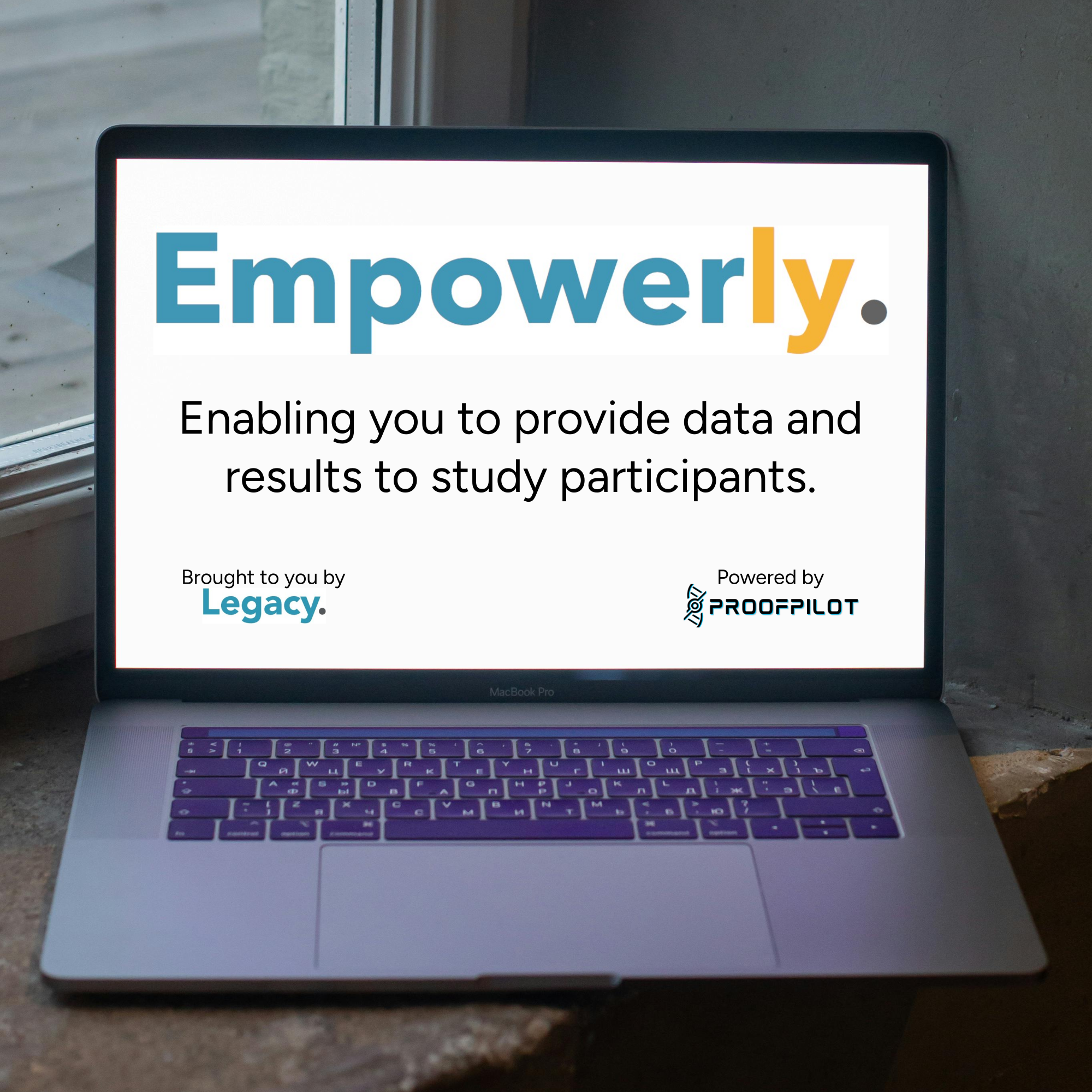 An open laptop sitting on a wooden table. The screen shows the logo for Empowerly followed by the text "Enabling you to provide data and results to study participants. Brought to you by Legacy Powered by ProofPilot." The company names are their respective logos.