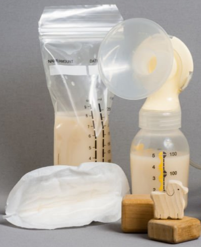 An image of a breastmilk pump and associated paraphernalia along with a few toy blocks.